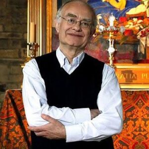 John Rutter, composer, in front of a colorful altar